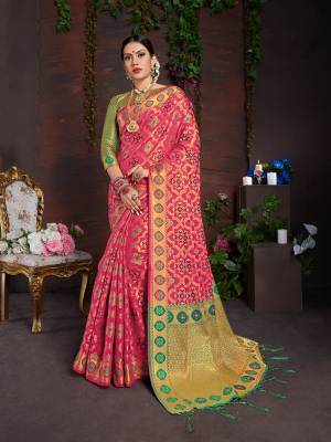 Bright And Visually Appealing Color Is Here With This Designer Saree In Rani Pink Color Paired With Contrasting Green Colored Blouse. This Saree And Blouse Are Fabricated On Lichi Art Silk Beautified With Heavy Weave All Over It. 