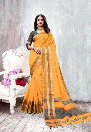 Celebrate This Festive Season Wearing This Designer Saree In Musturd Yellow Color Paired With Contrasting Grey Colored Blouse. This Saree And Blouse are Fabricated On Cotton Silk Beautified With Attractive Border. 