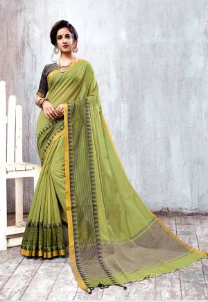 Celebrate This Festive Season Wearing This Designer Saree In Olive Green Color Paired With Contrasting Grey Colored Blouse. This Saree And Blouse are Fabricated On Cotton Silk Beautified With Attractive Border. 