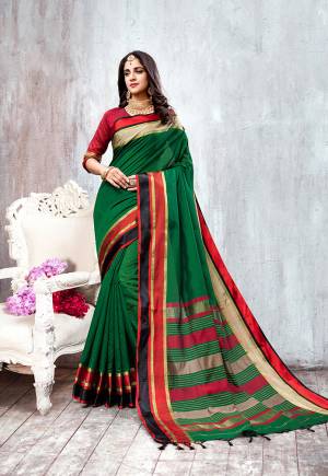 Enhance Your Personality In This Rich And Elegant Looking Saree In Dark Green Color Paired With Contrasting Red Colored Blouse. This Saree And Blouse Are Fabricated On Cotton Silk Which Is Light Weight And Easy To Carry All Day Long. 
