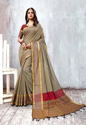 Celebrate This Festive Season Wearing This Designer Saree In Grey Color Paired With Contrasting Maroon Colored Blouse. This Saree And Blouse are Fabricated On Cotton Silk Beautified With Attractive Border. 