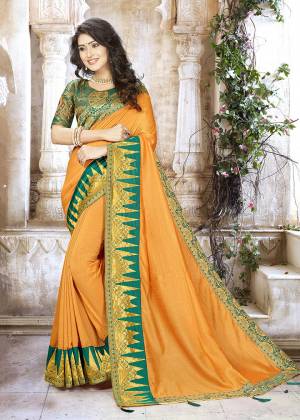 Celebrate This Festive Season Wearing This Designer Saree In Musturd Yellow Color Paired With Contrasting Teal Green Colored Blouse. This Saree Is Fabricated On Chinon Silk Paired With Jacquard Silk Fabricated Blouse. It Is Beautified With Weave And Attractive Embroidery. 