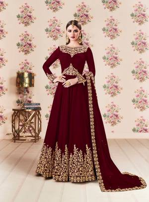 Add This Beautiful Designer Floor Length Suit To Your Wardrobe In Maroon Color Paired With Maroon Colored Bottom And Dupatta. Its Heavy Embroidered Top Is Fabricated On Georgette Paired With Santoon bottom And Georgette Fabricated Dupatta. Buy Now.