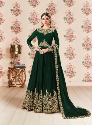 Add This Beautiful Designer Floor Length Suit To Your Wardrobe In Dark Green Color Paired With Dark Green Colored Bottom And Dupatta. Its Heavy Embroidered Top Is Fabricated On Georgette Paired With Santoon bottom And Georgette Fabricated Dupatta. Buy Now.