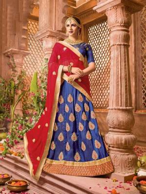 Bright And Visually Appealing Color Pallete Is Here With This Designer Lehenga Choli In Royal Blue Color Paired With Contrasting Red Colored Dupatta. Its Blouse And Lehenga Are Fabricated On Art Silk Paired With Chiffon Fabricated Dupatta. Buy Now.