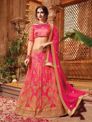 Shine Bright In This Beauitful Designer Heavy Lehenga Choli In All Over Dark Pink Color. Its Blouse And Lehenga Are Art Silk Based Paired With Chiffon Fabricated Dupatta. It Is Beautified With Heavy Jari And Thread Work. 