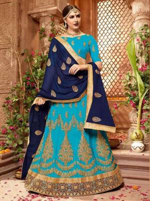Go With The Pretty Shades Of Blue With This Designer Lehenga Choli In Blue Color Paired With Navy Blue Colored Dupatta. This Lehenga Choli Is Fabricated On Art Silk Paired With Chiffon Fabricated Dupatta. Its Heavy Embroidery And Lovely Color Pallete Will Earn You Lots Of Compliments Form Onlookers.