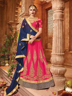 Go With The Pretty Shades This Season, With This Designer Lehenga Choli In Dark Pink Color Paired With Navy BLue Colored Dupatta. This Lehenga Choli Is Fabricated On Art Silk Paired With Chiffon Fabricated Dupatta. Its Heavy Embroidery And Lovely Color Pallete Will Earn You Lots Of Compliments Form Onlookers.