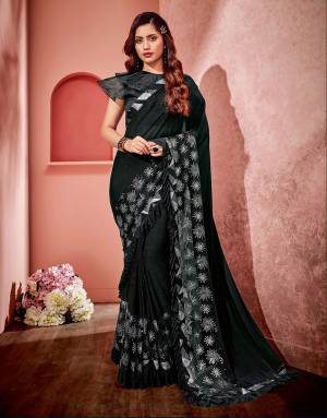 This black saree with its dramatic flair of frills and wonderful sequins set up is perfect for any occasion. Add multiple silver-side pins to look au current. 