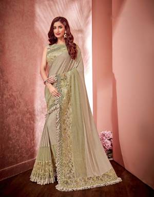 Fall in love with the classic beige saree with multiple ornamentations that will instantly inject life to your otherwise simple style.