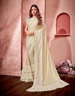 A great version for anyone who can't get enough of saree, this soft cream frill-infused design is a new-age muse. 