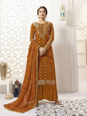 New And Unique Shade Is Here To Add Into Your Wardrobe With This Designer Straight Suit In Rust Orange Color Paired With Rust Orange Colored Bottom And Dupatta. Its Top IS Fabricated On Banarasi Silk Paired With Santoon Bottom And Chiffon Fabricated Dupatta. 