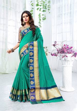 Add This Beautiful Designer Saree To Your Wardrobe For The Upcoming Festive And Wedding Season With This Silk Based Saree In Sea Green Color Paired With Contrasting Navy Blue Colored Blouse. This Saree Is Fabricated On Cotton Silk Paired With Brocade Fabricated Blouse. 