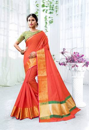Celebrate This Festive Season With Beauty, Comfort A Beautiful Touch Of Traditional Colors With This Designer Saree In Orange Color Paired With Contrasting Green Colored Blouse. This Saree Is Fabricated On Cotton Silk Paired With Brocade Fabricated Blouse. It Is Beautified With Weave Giving It An Enhanced Look.