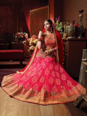 Add This Beautiful Heavy Designer Lehenga Choli For The Upcoming Wedding Season In Orange Colored Blouse Paired With Contrasting Dark Pink Colored Lehenga And Red Colored Dupatta. Its Blouse Is Fabricated On Art Silk Paired With Jacquard Net Fabricated Lehenga And Chiffon Fabricated Dupatta. 