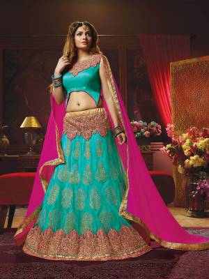 Look Beautiful In This Heavy Designer Lehenga Choli In Turquoise Blue Color Paired With Contrasting Rani Pink Colored Dupatta. This Pretty Lehenga Choli Is Perfect For Bridesmaid Which Is Beautified With Heavy And Attractive Embroidery. Its Blouse Is Art Silk Fabricated Paired With Jacquard Net Lehenga And Chiffon Fabricated Dupatta. 