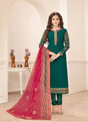Here Is A Very Beautiful Designer Straight Suit In Teal Green Paired With Contrasting Dark Pink Colored Dupatta. Its Top Is Fabricated On Georgette Paired With Santoon Bottom And Georgette Fabricated Dupatta. Its Top And Dupatta Are Beautified With Heavy Embroidery Giving It An Attractive Look.