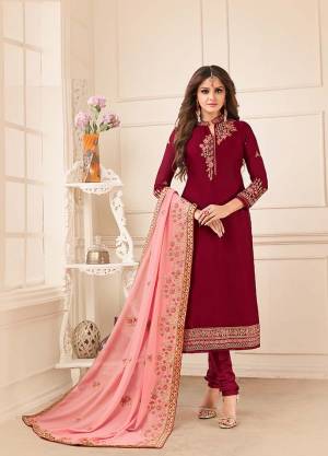 Grab This Royal Looking Heavy Designer Straight Suit In Maroon Color Paired With Contrasting Peach Colored Dupatta. Its Embroidered Top Is Fabricated On Satin Georgette Paired With Santoon Bottom And Georgette Fabricated Dupatta. Buy Now.