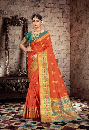 Celebrate This Festive Season With Beauty And Comfort With This Designer Saree In Orange Color Paired With Contrasting Teal Blue Colored Blouse. This Saree Is Fabricated On Cotton Silk Paired With Art Silk Fabricated Blouse. 