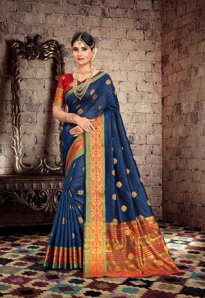 Here Is A Very Pretty Designer Saree For The Upcoming Festive And Wedding Season. Grab This Pretty Saree In Navy Blue Color Paired With Contrasting Red Colored Blouse. This Saree Is Fabricated On Cotton Silk Paired With Art Silk Fabricated Blouse. Buy This Saree Now.