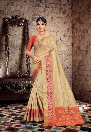 Celebrate This Festive Season With Beauty And Comfort With This Designer Saree In Beige Color Paired With Contrasting OrangeColored Blouse. This Saree Is Fabricated On Cotton Silk Paired With Art Silk Fabricated Blouse. 