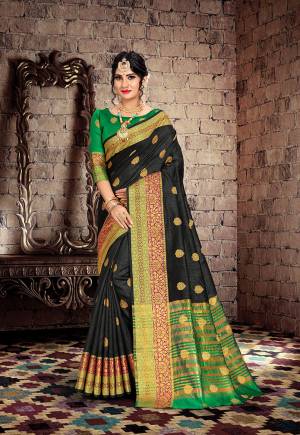 Here Is A Very Pretty Designer Saree For The Upcoming Festive And Wedding Season. Grab This Pretty Saree In Black Color Paired With Contrasting Green Colored Blouse. This Saree Is Fabricated On Cotton Silk Paired With Art Silk Fabricated Blouse. Buy This Saree Now.
