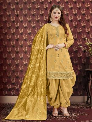 Celebrate This Festive Season Wearing This Designer Suit In Yellow Color. Its Pretty Embroidered Top Is Fabricated On Art Silk Paired With Santoon Bottom And Jacquard Silk Fabricated Dupatta. It Is Beautified With Attractive Gota Patti Work. Buy Now.