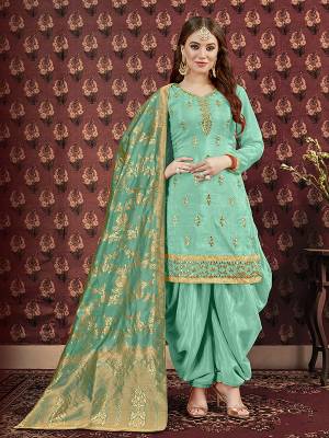 Celebrate This Festive Season Wearing This Designer Suit In Sea Green Color. Its Pretty Embroidered Top Is Fabricated On Art Silk Paired With Santoon Bottom And Jacquard Silk Fabricated Dupatta. It Is Beautified With Attractive Gota Patti Work. Buy Now.