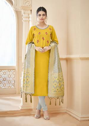 Celebrate This Festive Seaon Wearing This Designer Straight Suit In Yellow Colored Top Paired With Contrasting Pale Grey Colored Bottom And Dupatta. Its Top And Bottom Are Cotton Based Paired With Banarasi Jacquard Fabricated Dupatta. Buy Now.