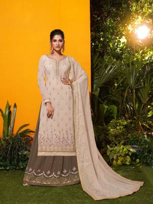 Grab This Very Beautiful Designer Suit In Cream Colored Top Paired With Dark Grey Colored Bottom And Cream Colored Dupatta. Its Top, Bottom And Dupatta Are Fabricated On Georgette Beautified With Attractive Embroidery.