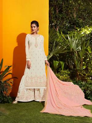 Flaunt Your Rich And Elegant Taste Wearing This Designer Suit In White Colored Top And Bottom Paired With Peach Colored Dupatta. This Suit Is Fabricated On Georgette Beautified With Attractive Embroidery Over It, Buy Now.