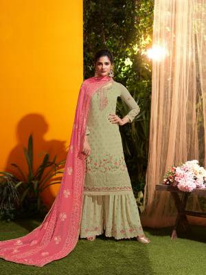 New Shade Is Here To Add Into Your Wardrobe With This Designer Suit In Sand Grey Color Paired With Contrasting Pink Colored Dupatta. Its Top, Bottom And Dupatta Are Fabricated On Georgette Beautified With Attractive Contrasting Embroidery. 
