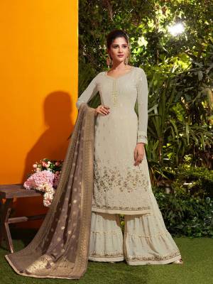Simple And Elegant Looking Designer Suit Is Here In Cream Colored Top And Bottom Paired With Contrasting Brown Colored Dupatta. Its Top And Bottom Are Georgette Based Paired With Jacquard Silk Fabricated Dupatta. All Its Fabrics Ensures Superb Comfort Throughout The Gala.