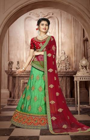 Here Is A Very Beautiful Designer Lehenga Choli For The Upcoming Wedding Season. Its Blouse And Dupatta Are In Maroon Color Paired With Contrasting Green Colored Lehenga. This Lehenga Choli Is Fabricated On Art Silk Paired With Net Fabricated Dupatta. Buy This Lovely Ethnic Color Pallete Lehenga Choli Now.