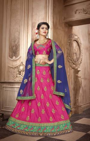 Look Pretty In This Designer Lehenga Choli In Dark Pink Color Paired With Contrasting Royal Blue Colored Dupatta. Its Blouse And Lehenga Are Fabricated On Art Silk Paired With Net Fabricated Dupatta. It Is Light Weight And Easy To Carry All Day Long. 