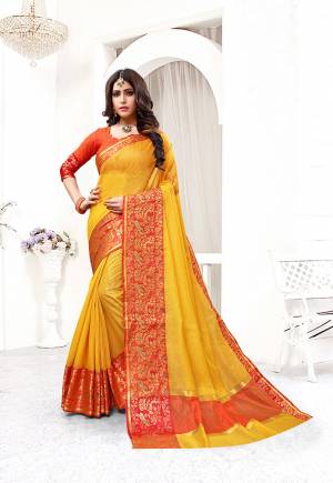 This Festive Season Be The Most Pretty And Elegant Of All Wearing This Saree In Yellow Color Paired With Contrasting Orange Colored Blouse. This Saree And Blouse Are Fabricated On Cotton Silk Beautified With Weaved Lace Border. 