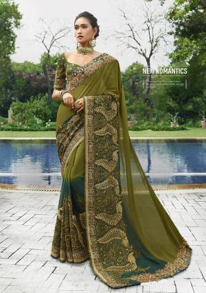 An Amazing Glam Look For The Upcoming Wedding Season Is Here With This Designer Saree In Olive Green And Peacock Blue Color Paired With Olive Green Colored Blouse. This Saree IS Fabricated On Georgette Paired With Art Silk Fabricated Blouse Beautified With Heavy Embroidery All Over. 