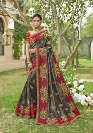 New and Unique Look Is Here With This Heavy designer Saree In Dark Grey Color Paired With Contrasting Red Colored Blouse. This Heavy Embroidered Saree And Blouse are Fabricated On Art Silk. It Heavy Embroidery, Rich Fabric And Color Pallete Will Earn You Lots Of Compliments From Onlookers. 
