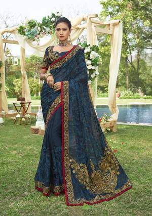 Enhance Your Personality Wearing This Heavy Designer Saree In Dark Blue Color Paired With Dark Blue Colored Blouse. This Heavy Embroidered Saree Is Chiffon Based Paired With Art Silk Fabricated Blouse. It IS Beautified With Subtle Tone To Tone Embroidery And Also JAri Work. Buy Now.