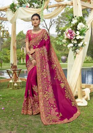 Bright And Visually Appealing Color Is Here With This Heavy Designer Saree In Dark Pink Color Paired With Dark Pink Colored Blouse. This Saree Is Fabricated On satin Silk Paired With Art Silk Fabricated Blouse. It Has Very Beautiful And Heavy Embroidery Making The Saree Attractive. 