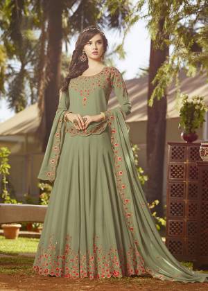 Simple And Elegant Looking Designer Floor Length Suit Is Here In Olive Green Color Paired With Olive Green Colored Bottom And Dupatta. Its Top And Dupatta Are Georgette Fabricated Beautified With Contrasting Embroidery Paired With Santoon Bottom. It Is Light In Weight And Easy To Carry All Day Long. 