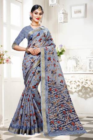For Your Work Place And Comfort, Grab This Printed Saree In Grey Color Paired With Grey Colored Blouse. This Saree And Blouse are Fabricated On Cotton Silk Beautified With Floral Prints All Over It. Buy This Saree Now.