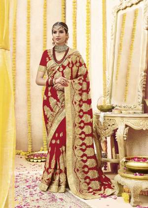 Here Is Beautiful Collection In Bridal Sarees With This Designer Saree In Red Color Paired With Red Colored Blouse. This Saree And Blouse are fabricated On Georgette Beautified With Heavy Jari Embroidery And Stone Work. This Beautiful Heavy Saree Will A Proper Bridal Look And Will Earn You Lots Of Compliments From Onlookers.