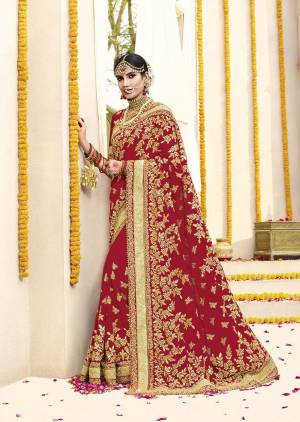 Here Is Beautiful Collection In Bridal Sarees With This Designer Saree In Red Color Paired With Red Colored Blouse. This Saree And Blouse are fabricated On Georgette Beautified With Heavy Jari Embroidery And Stone Work. This Beautiful Heavy Saree Will A Proper Bridal Look And Will Earn You Lots Of Compliments From Onlookers.