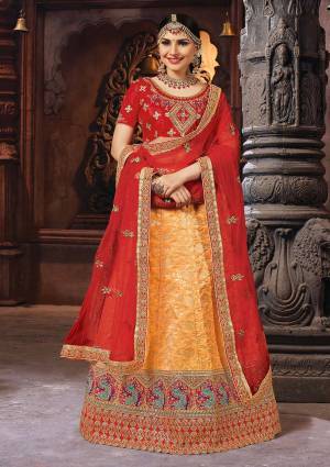 Celebrate This Festive And Weddding Seaosn With Beauty With This Designer Lehenga Choli In Red Colored Blouse Paired With Orange Colored Lehenga And Maroon Colored Dupatta. Its Blouse Is Fabricated On Art Silk Paired With Banarasi Jacquard Silk Lehenga And Net Fabricated Dupatta. 