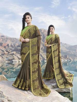 New And Unique Shade Is Here In Trend To Add Into Your Wardrobe With This Designer Saree In Dark Brown Color Paired With Contrasting Light Green Colored Blouse. This Saree Is Fabricated On Silk Georgette Beautified With Heavy Embroidery Paired With Art Silk Fabricated Blouse. 