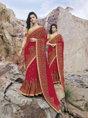 Here Is A Proper Traditional And Evergreen Color Pallete With This Heavy designer Saree In Red Color Paired With Beige Colored Blouse. This Heavy Embroidered Saree Is Fabricated On Georgette Paired With Art Silk Fabricated Blouse. Buy Now.