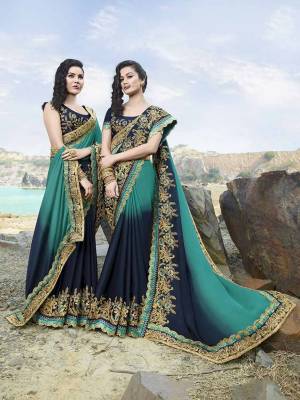 Go With The Pretty Shades Of Blue With This Heavy Designer Saree In Blue And Navy Blue Color Paired With Navy Blue Colored Blouse. This Saree IS Satin based Paired With Art Silk Fabricated Blouse. It Is Beautified With Heavy Embroidery Giving It An Attractive Look.