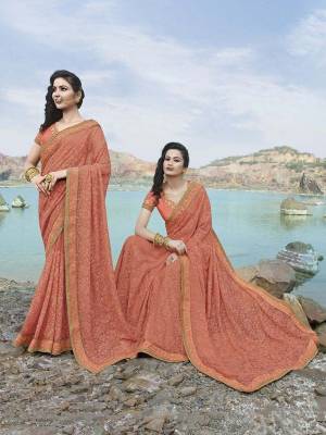 Look Pretty And Earn Lots Of Compliments Wearing This Heavy Designer Saree In Peach Color Paired With Peach Colored Blouse. This Heavy Tone To Tone Embroidered Saree Is Fabricated On Chiffon Paired With Art Silk Fabricated Blouse. Its Pretty Color And Embroidery Will Give A Beautiful look Like Never Before.
