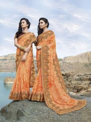 Trending Shade Is Here To Add Into Your Wardrobe With This Designer Saree In Orange Color Paired With Contrasting Brown Colored Blouse. This Saree Is Fabricated On Silk Georgette Beautified With Heavy Embroidery Paired With Art Silk Fabricated Blouse. 
